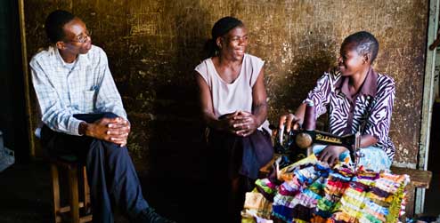 Development worker in Zimbabwe talks to two women